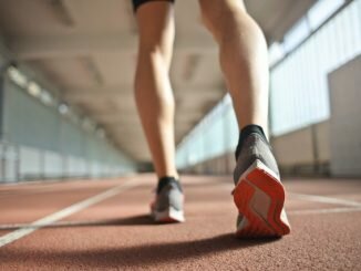 fit runner standing on racetrack in athletics arena 3756165